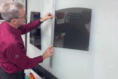 Darren carefully measuring a vehicle window tint film