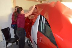 Side view of vinyl wrap being applied