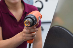Lily in the process of colour wrapping a car