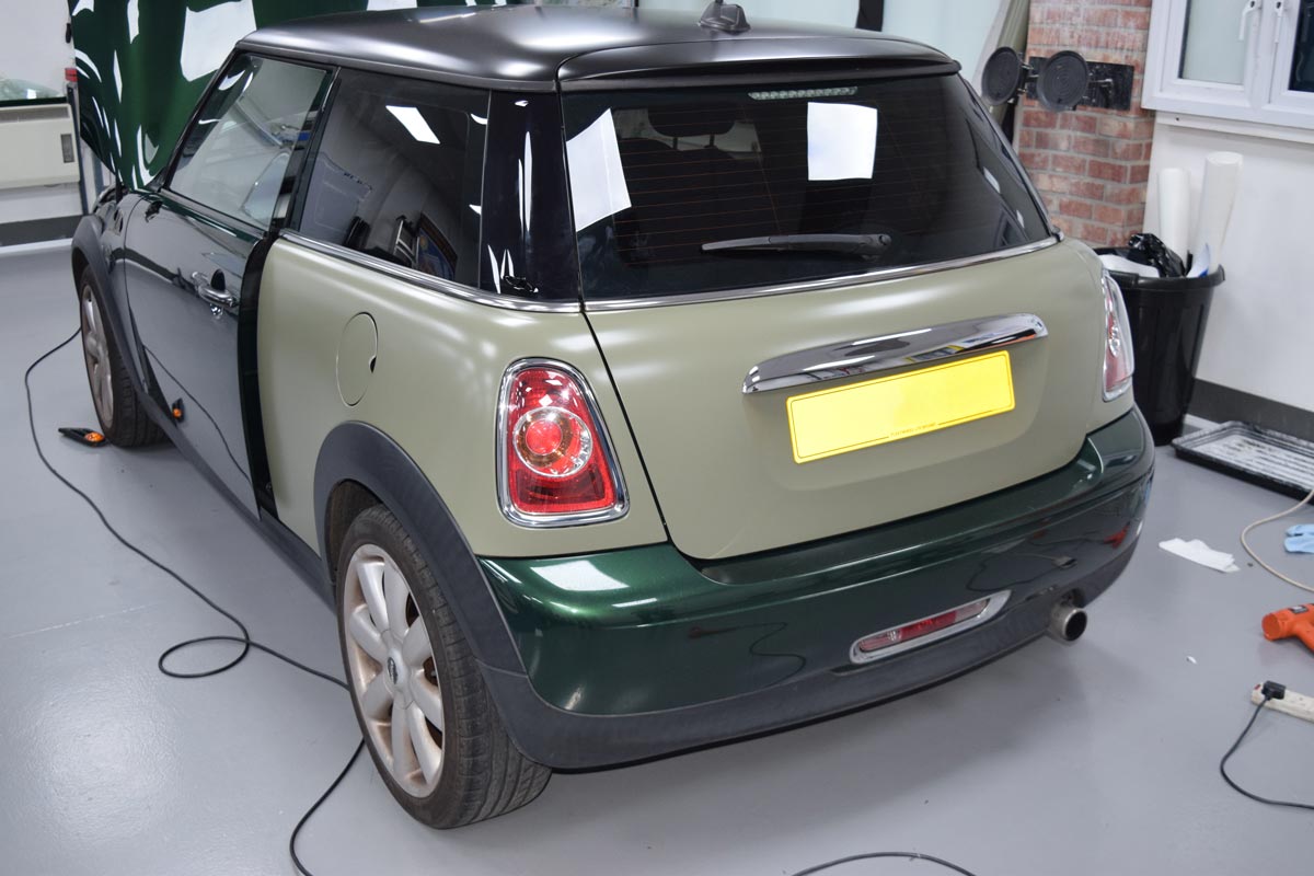 A Mini vehicle in the process of having a vinyl wrap applied