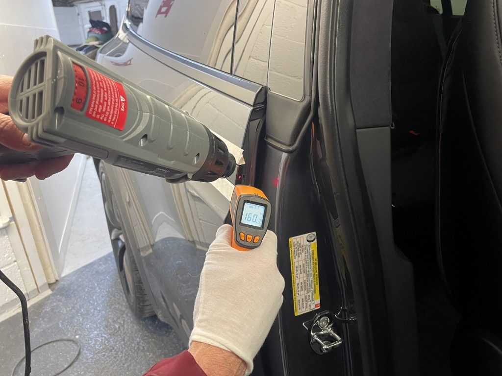 Tesla Model X SUV using a themometer to check sealing temperature